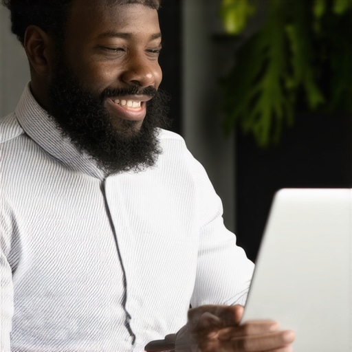 Business owner working on Google My Business listing on laptop and smartphone